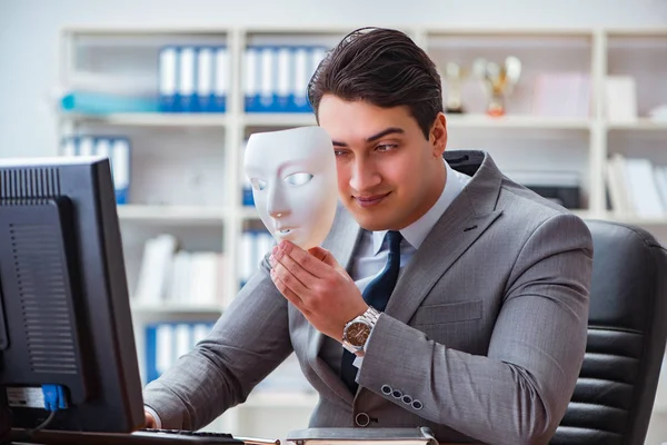 Businessman with mask in office hypocrisy concept — Stock Photo, Image