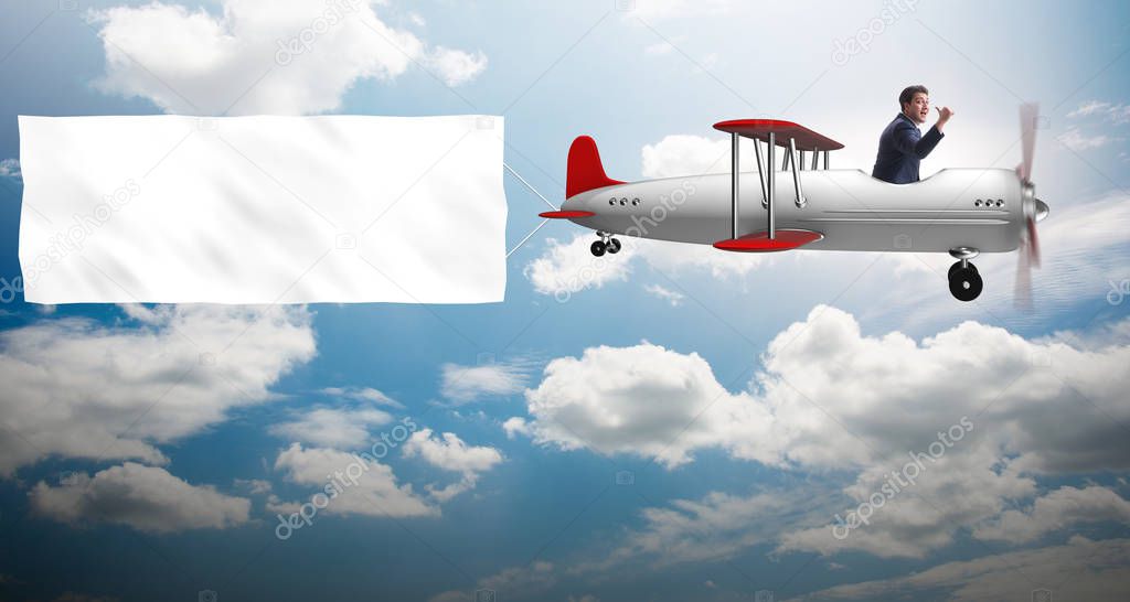 Biplane with businessman and blank banner