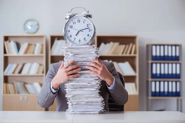 Empresário ocupado com papelada no escritório — Fotografia de Stock