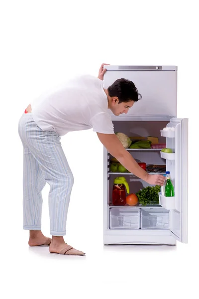 Man next to fridge full of food — Stock Photo, Image