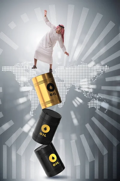Arabische zakenman verliest evenwicht op olievaten — Stockfoto