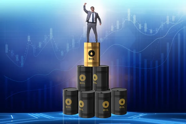 Businessman on top of oil barrels — Stock Photo, Image