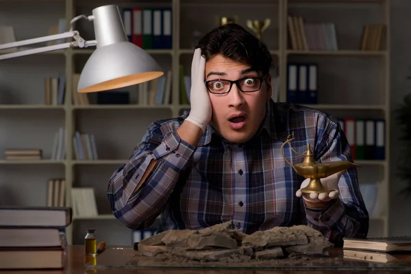 Archeologist working late night in office — Stock Photo, Image