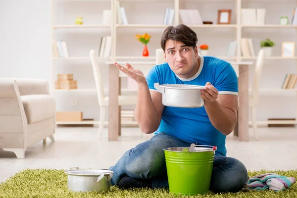 Man at home dealing with neighbor flood leak — Stock Photo, Image