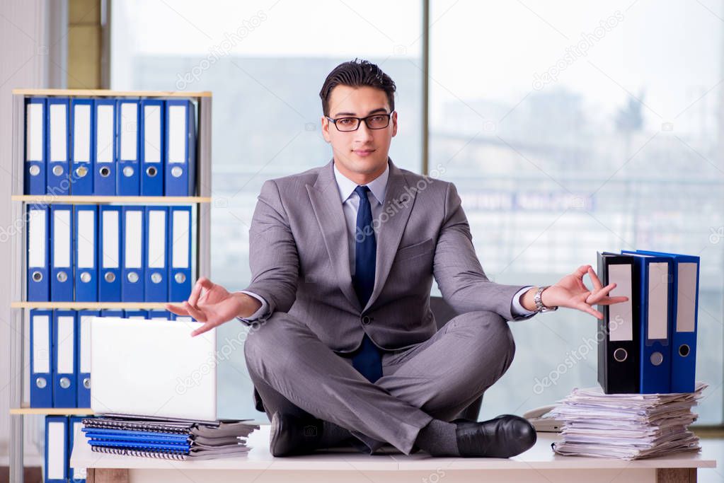Businessman meditating in the office