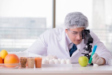 Besin uzmanı gıda ürünlerini laboratuarda test ediyor.