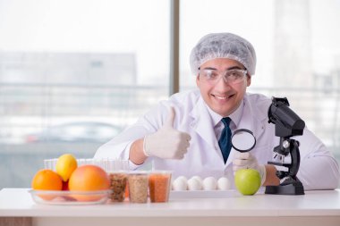 Besin uzmanı gıda ürünlerini laboratuarda test ediyor.