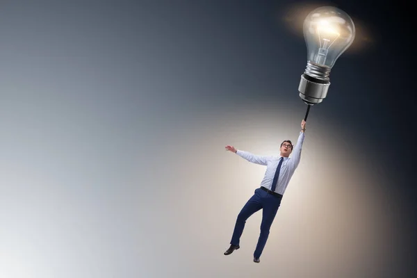 Businessman flying on lamp balloon — Stock Photo, Image
