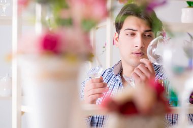 Genç yakışıklı dükkândan alışveriş yapıyor.