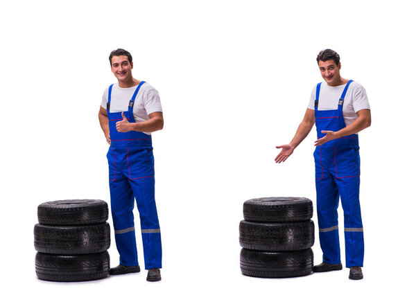 Handsome tyre repairman isolated on white