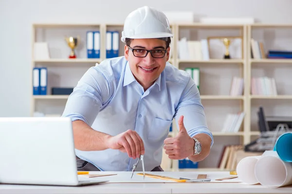 Male engineer working on drawings and blueprints — Stock Photo, Image