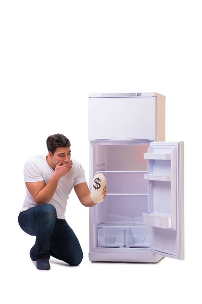 Hungry man looking for money to fill the fridge — Stock Photo, Image