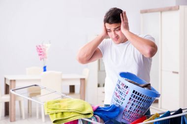 Man doing laundry at home clipart