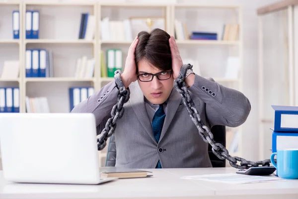 Businessman tied with chains to his work — Stock Photo, Image
