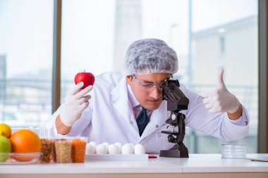 Besin uzmanı gıda ürünlerini laboratuarda test ediyor.