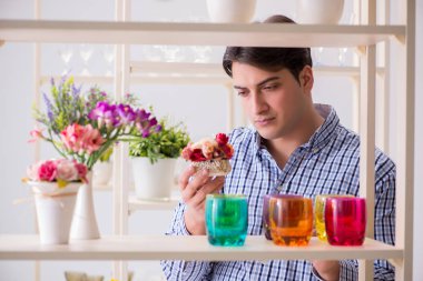 Genç yakışıklı dükkândan alışveriş yapıyor.