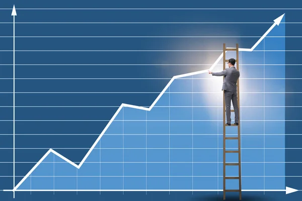 Businessman drawing charts standing on ladder — Stock Photo, Image