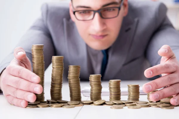 Businessman with golden coins in business growth concept — Stock Photo, Image