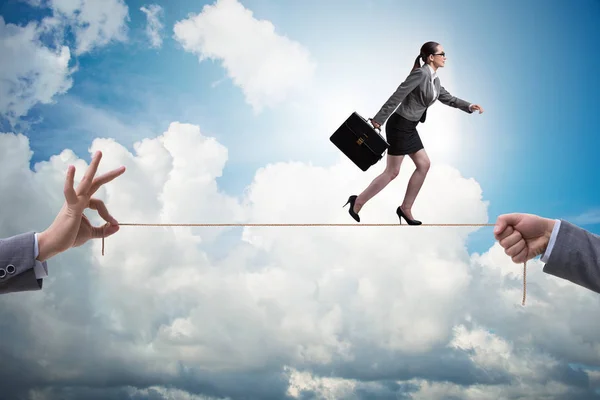 Businesswoman walking on tight rope in business concept — Stock Photo, Image