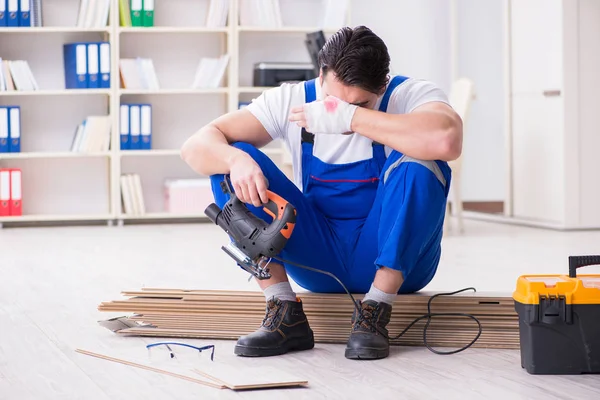 Zemin kaplamalarında çalışan genç bir işçi.