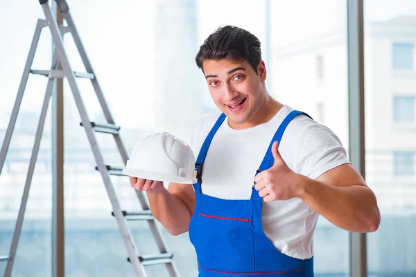 Young worker with safety helmet hardhat