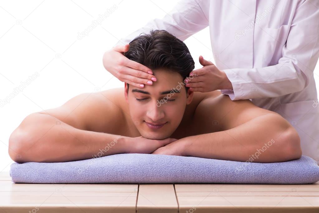 Handsome man in spa massage concept