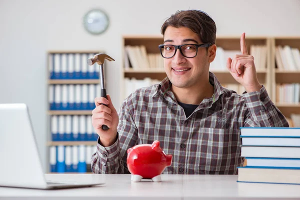 Jovem estudante quebrando banco porquinho para comprar livros didáticos — Fotografia de Stock