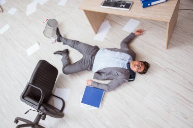 Businessman dead on the office floor clipart