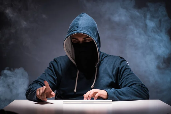 Computer hacker working in dark room — Stock Photo, Image