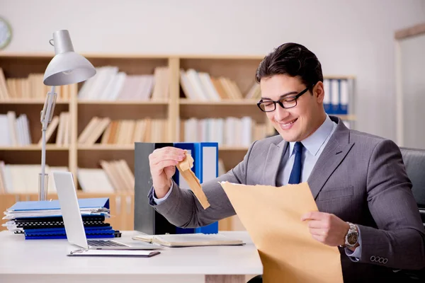 Businessman receiving letter envelope in office