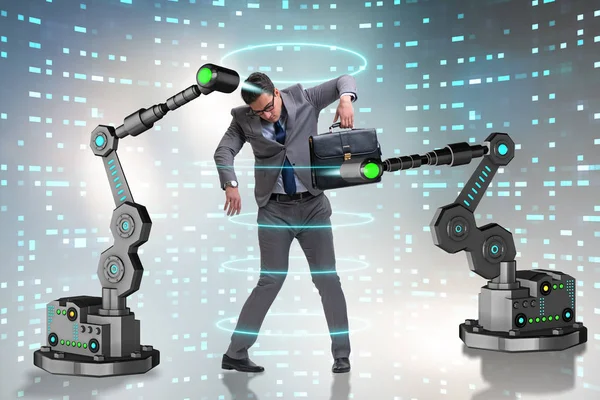 Businessman being manipulated by robotic arms — Stock Photo, Image