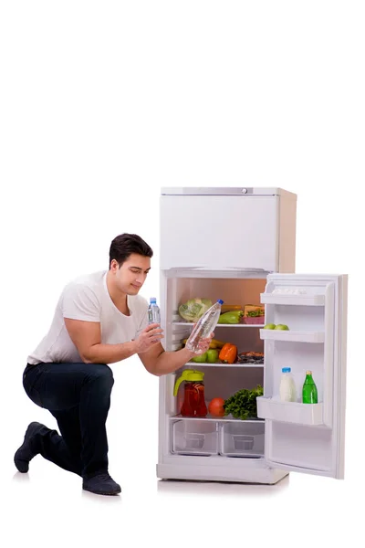 Man next to fridge full of food — Stock Photo, Image