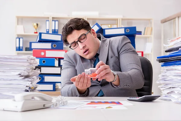 Businessman taking pills to cope with stress — Stock Photo, Image