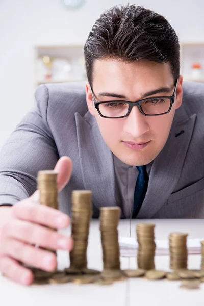 Businessman with golden coins in business growth concept — Stock Photo, Image