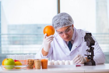 Besin uzmanı gıda ürünlerini laboratuarda test ediyor.