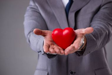 Aşk kavramı kırmızı kalp tutan işadamı