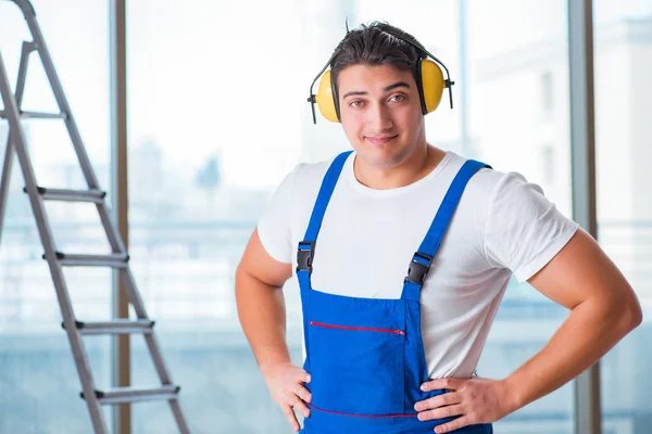 Worker with noise cancelling headphones