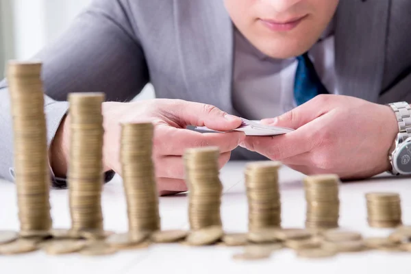 Businessman with golden coins in business growth concept — Stock Photo, Image