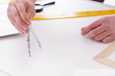 Erkek mühendis çizimler ve planlar üzerinde çalışıyor.