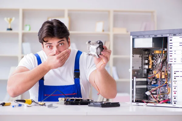 Computer repairman repairing desktop computer