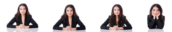 Junge Geschäftsfrau sitzt am Schreibtisch auf weiß — Stockfoto