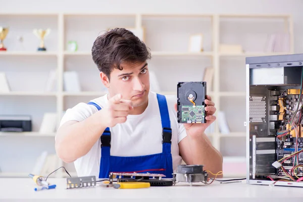 Computer repairman repairing desktop computer