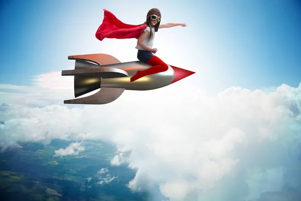 Süper kahraman kavramında küçük bir kız roket uçuruyor. — Stok fotoğraf