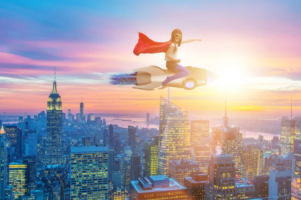 Little girl flying rocket in superhero concept — Stock Photo, Image
