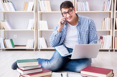 Genç öğrenci kitaplarla çalışıyor.