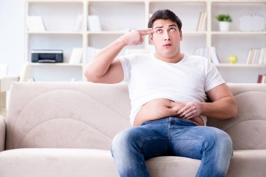 Diyet konseptinde fazladan ağırlık çeken adam.