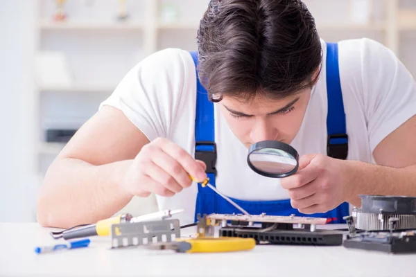 Computer repairman repairing desktop computer