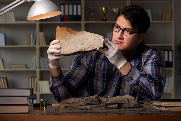 Archeologist working late night in office — Stock Photo, Image