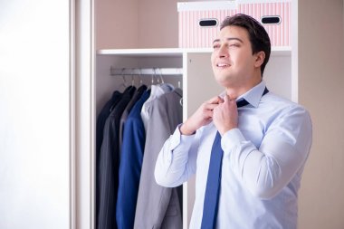 Genç işadamı iş için giyiniyor.