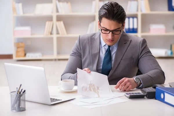 Businessman spilling coffee on important documents — Stock Photo, Image